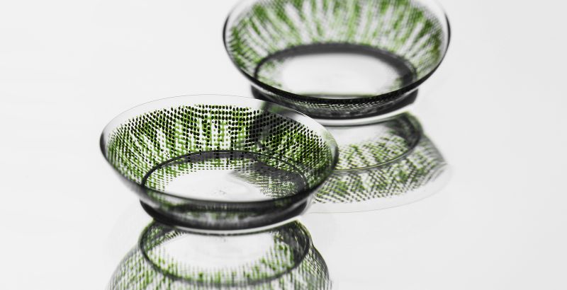 green contact lenses on light background with reflection